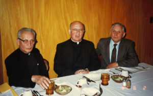 1984 UNA Member sitting with two priests and talking