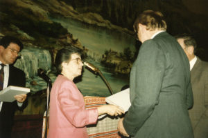1994 UNA Jersey District 100th Anniversary Man receiving a book