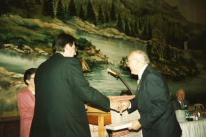 1994 UNA Jersey District 100th Anniversary Men Shaking Hands